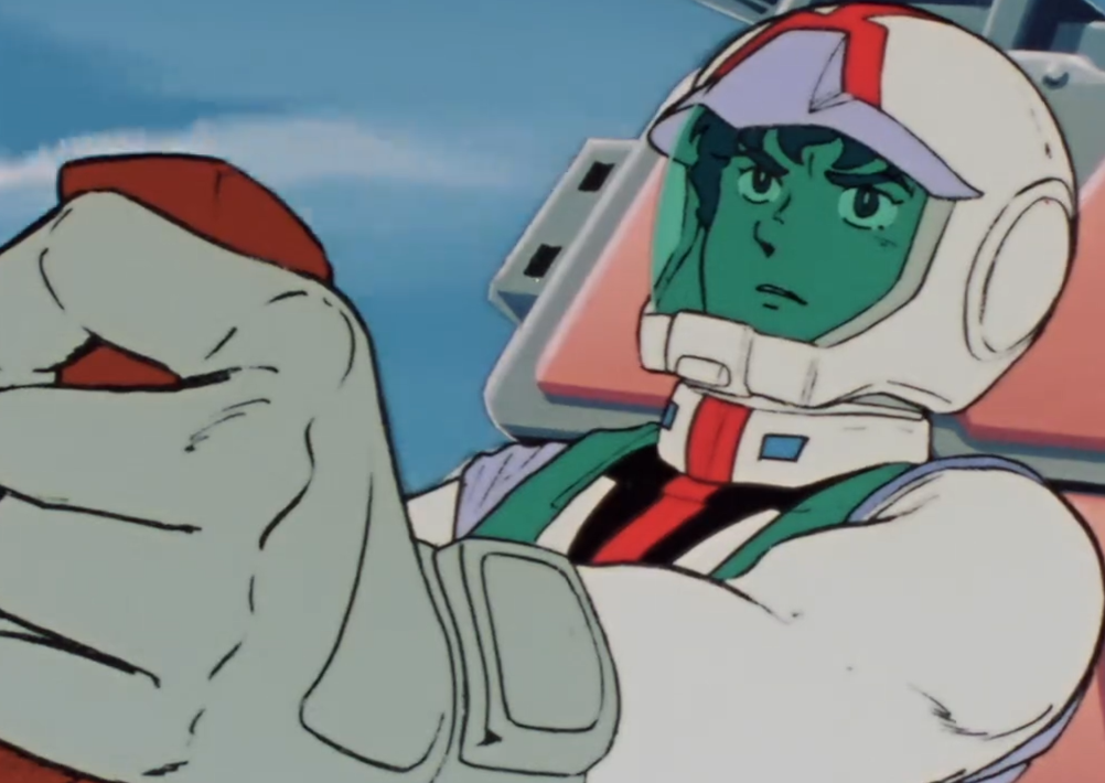 Amuro Ray wearing a normal suit and piloting the Gundam, one hand on its controls in Mobile Suit Gundam Episode 15