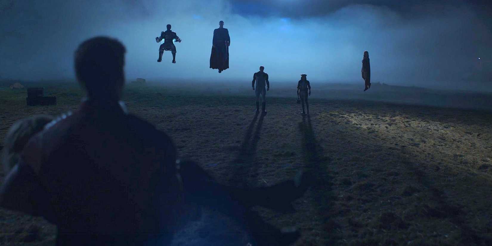 Peacemaker, back to camera, carrying Harcourt with Mister Terrific Superman Guy Gardner Hawkgirl and Supergirl in silhouette from Peacemaker Season 2