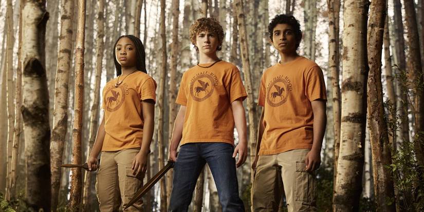 Annabeth, Percy, and Grover in their Camp Half-Blood shirts.