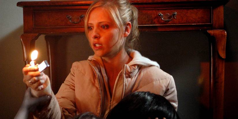 A ghost grabs Karen's hand while she is holding a lighter in The Grudge (2004)