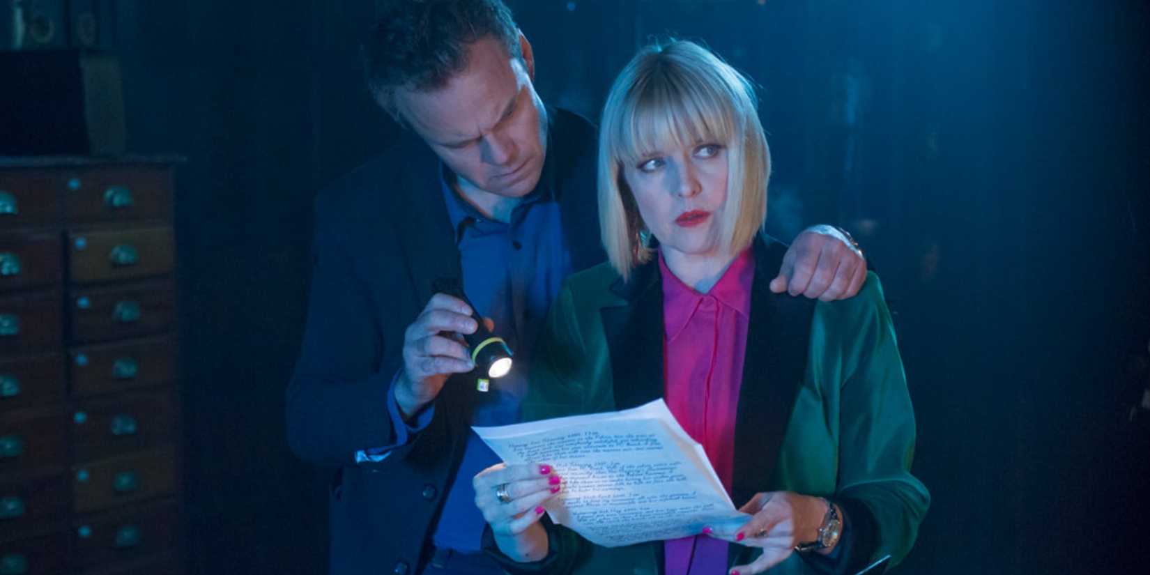 Agatha holding a letter to Agatha Raisin