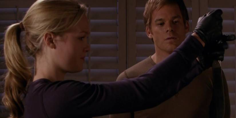 Lumen holding up a knife as Dexter looks on.