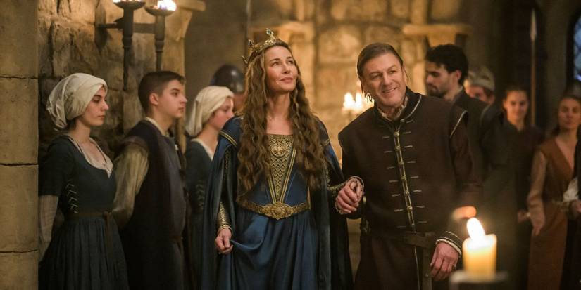 Queen Eleanor and the Sheriff of Nottingham walking past servants in Robin Hood