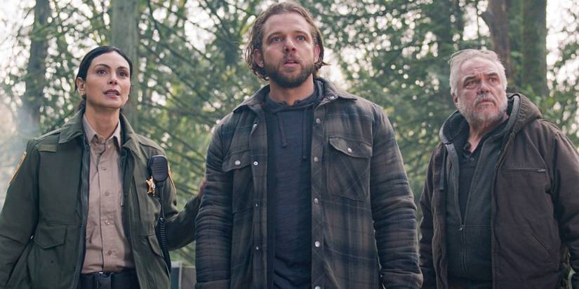 Morena Baccarin as Mickey, Max Thieriot as Bode, and W. Earl Brown as Wes in the woods on Fire Country 'Dirty Money'