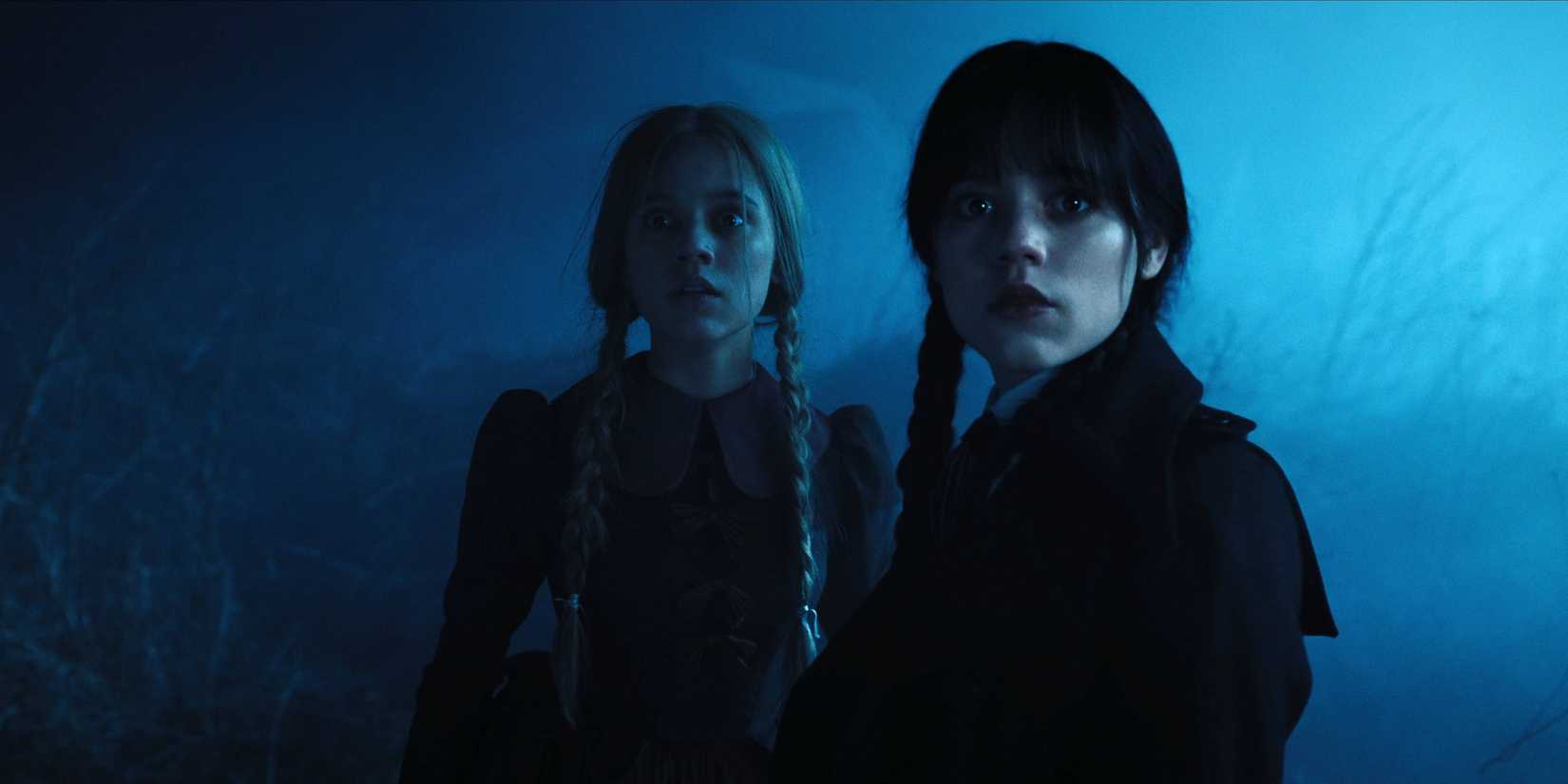 Wednesday and Goody looking frightened in the dark in Wednesday.