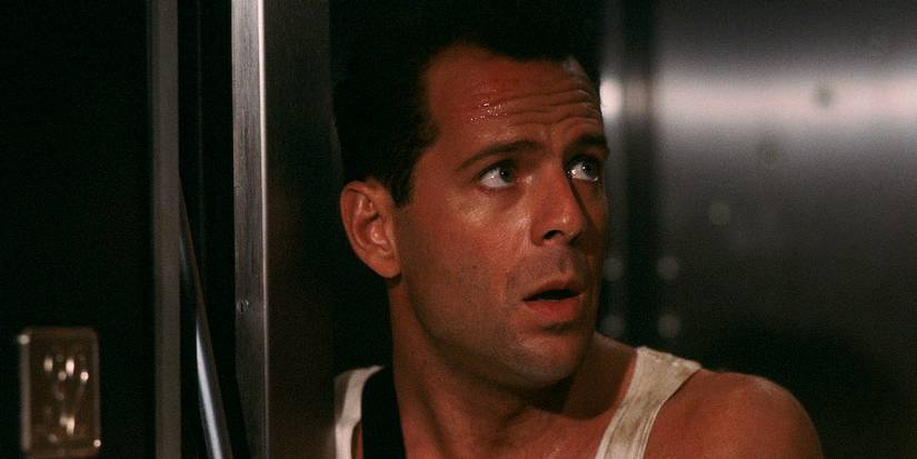 John McClane stands in an elevator shaft in Die Hard