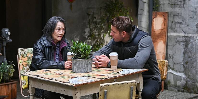 Freda Foh Shen as Barbie Lee and Justin Hartley as Colter Shaw drinking coffee in Tracker 'The Night Movers'