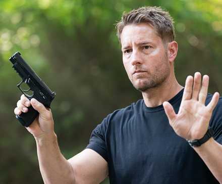 Justin Hartley as Colter Shaw with hands raised in Tracker 'The Old Ways'