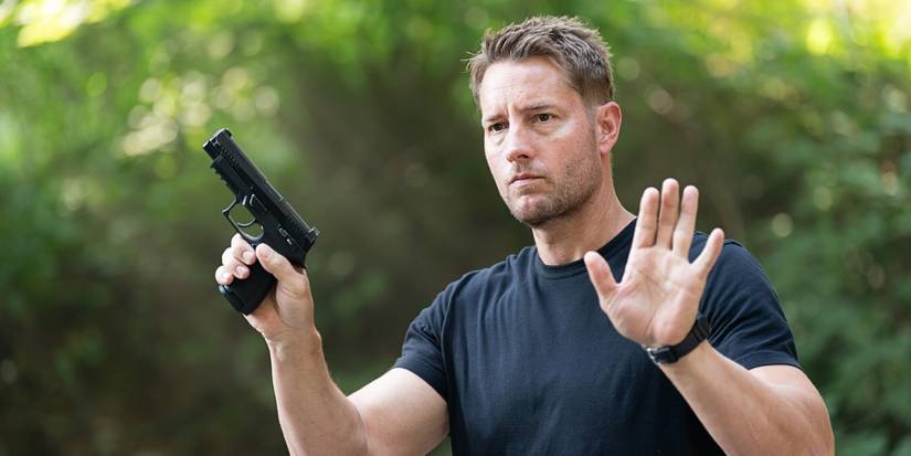 Justin Hartley as Colter Shaw with hands raised in Tracker 'The Old Ways'