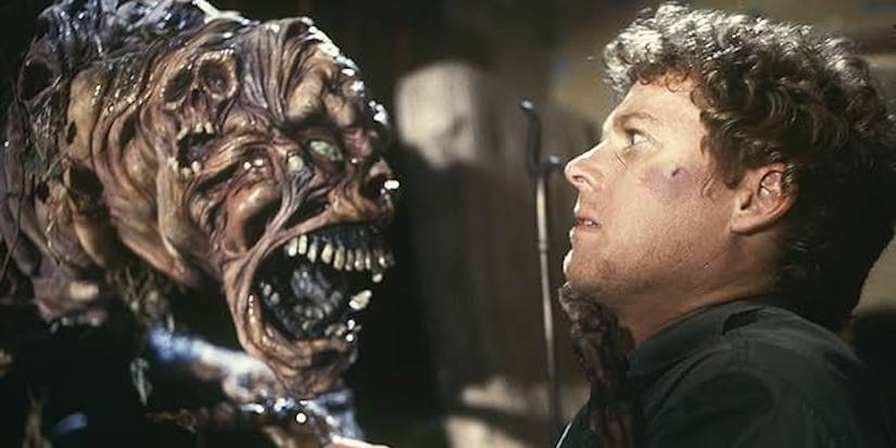 Arthur Cobb (William Katt) watches nervously as the grotesque demon lunges at him.