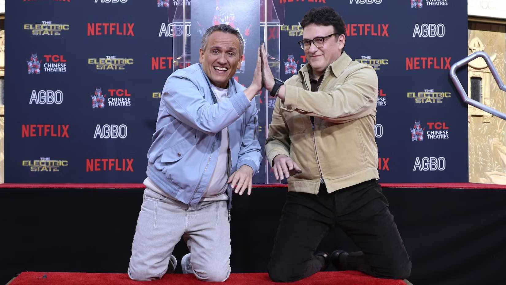 Joe and Anthony Russo high-fiving at the premiere of The Electric State