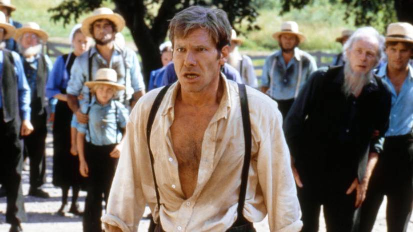 Harrison Ford looks angry with an open shirt in Witness 1985