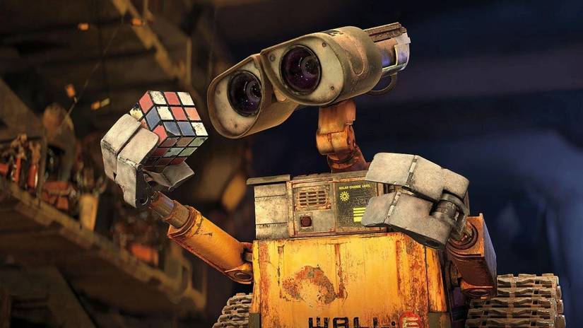 WALL-E looks at a rubrik's cube in WALL-E
