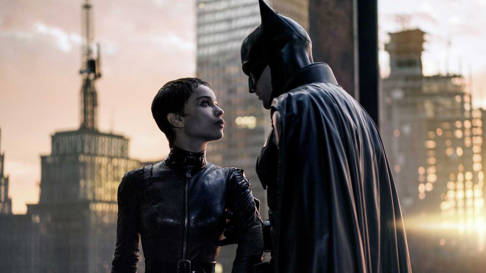 Batman grabbing Catwoman's arm with Gotham City in the background from The Batman