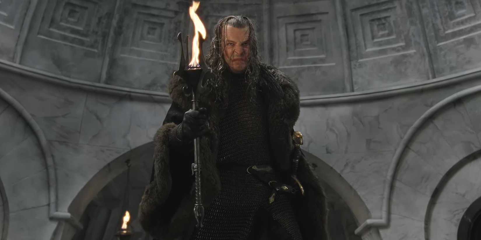 Denethor holding a torch in The Lord of the Rings: The Return of the King