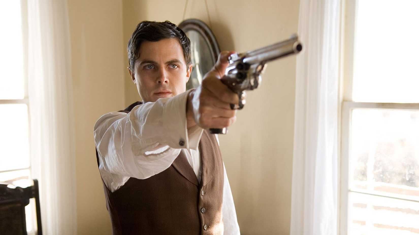 Robert Ford points a revolver in The Assassination of Jesse James by the Coward Robert Ford
