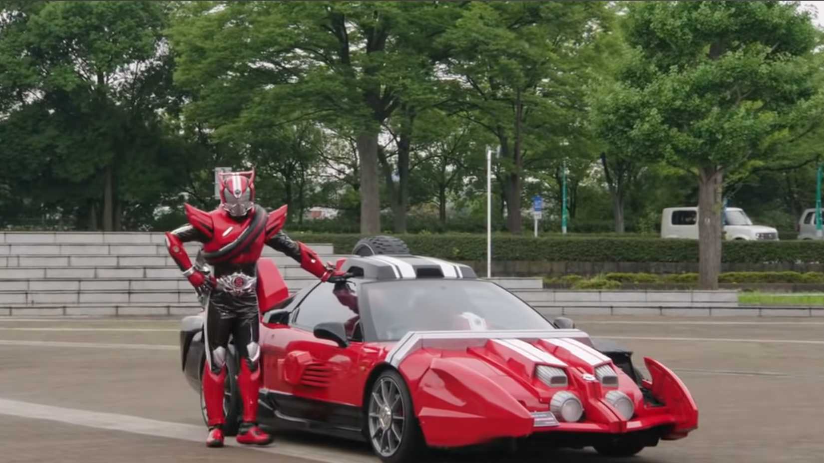Kamen Rider Drive standing next to his car