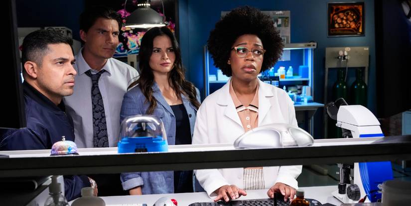 NCIS Special Agent Torres, Special Agent Sawyer, NCIS Special Agent Knight, and Forensic Scientist Kasie Hines look at a computer to investigate a murder in NCIS Season 23 'The Sound and the Fury'