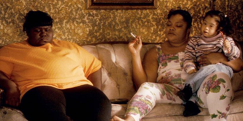 Precious sitting on the couch with her mother Mary and daughter Mongo