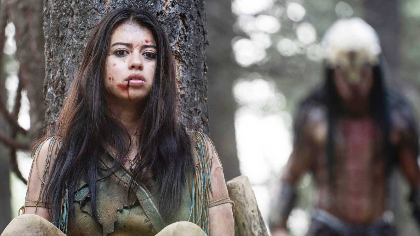 Naru (Amber Midthunder) hides from a Predator in Prey