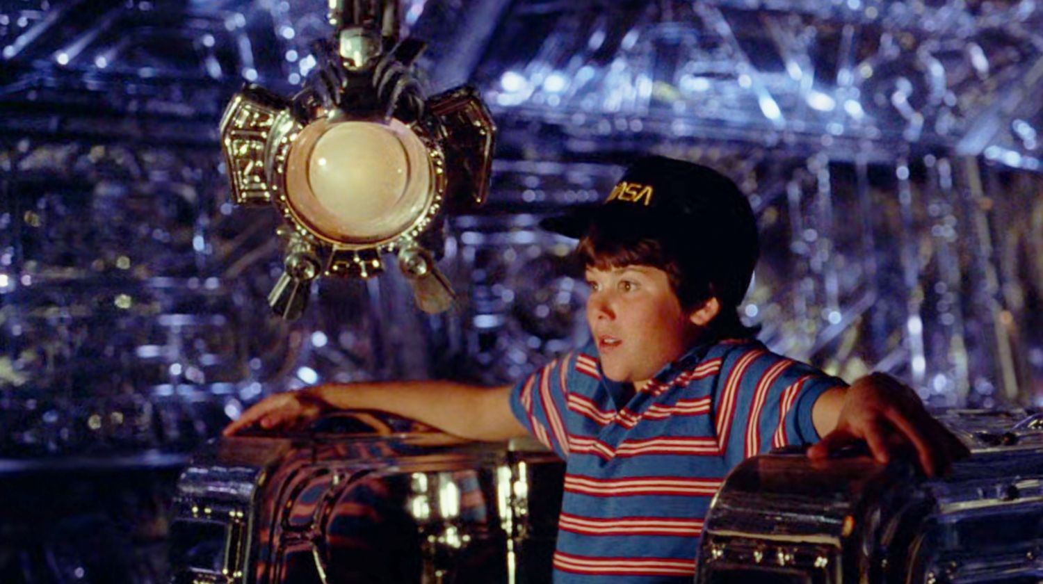 David Freeman sits next to Max inside the spaceship in Flight of the Navigator