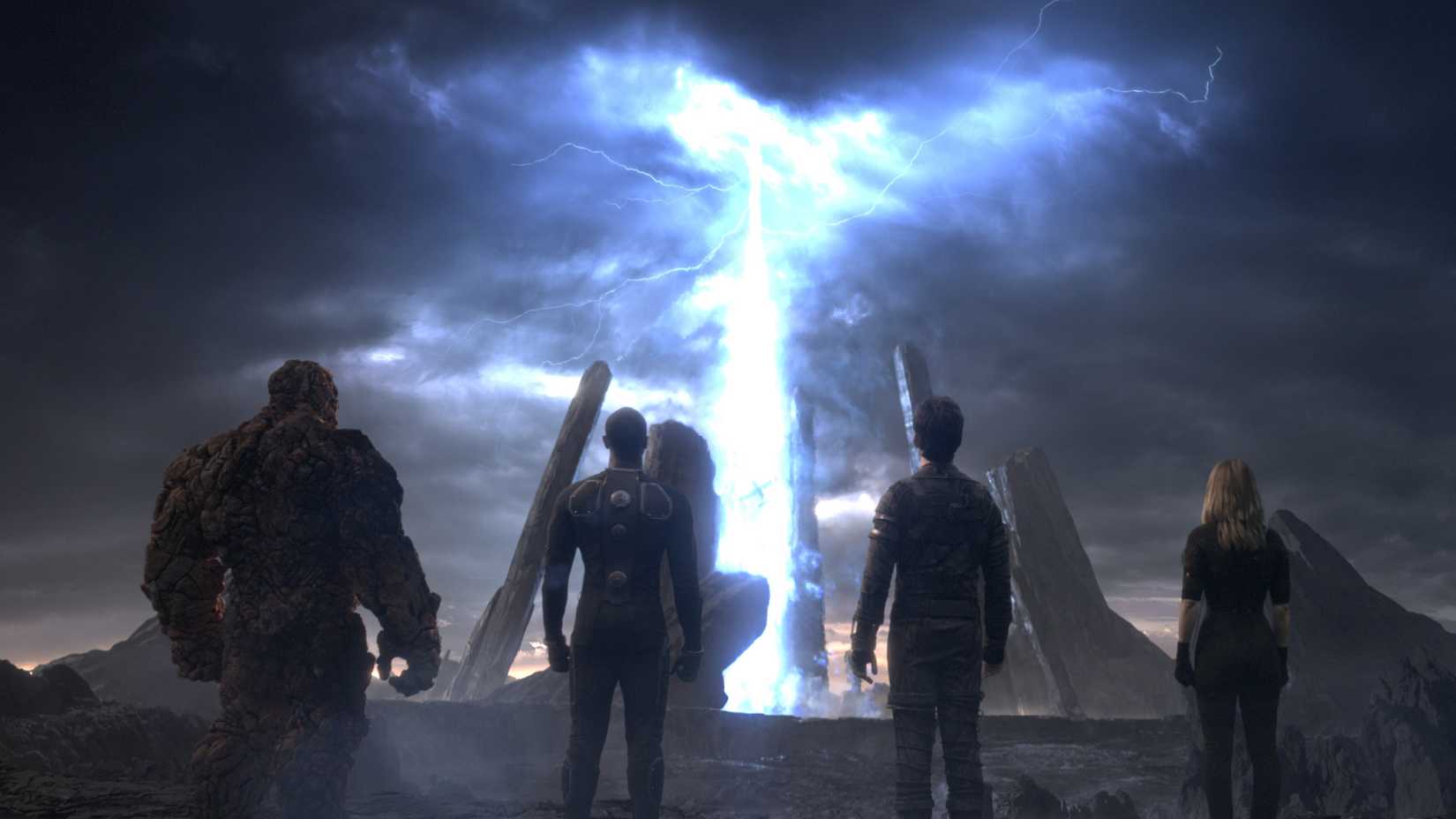 The cast of 2015's Fantastic Four staring at a giant portal in the sky