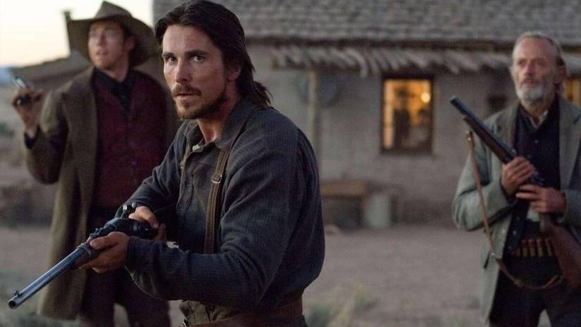 Dan Evans holds his rifle outside his home