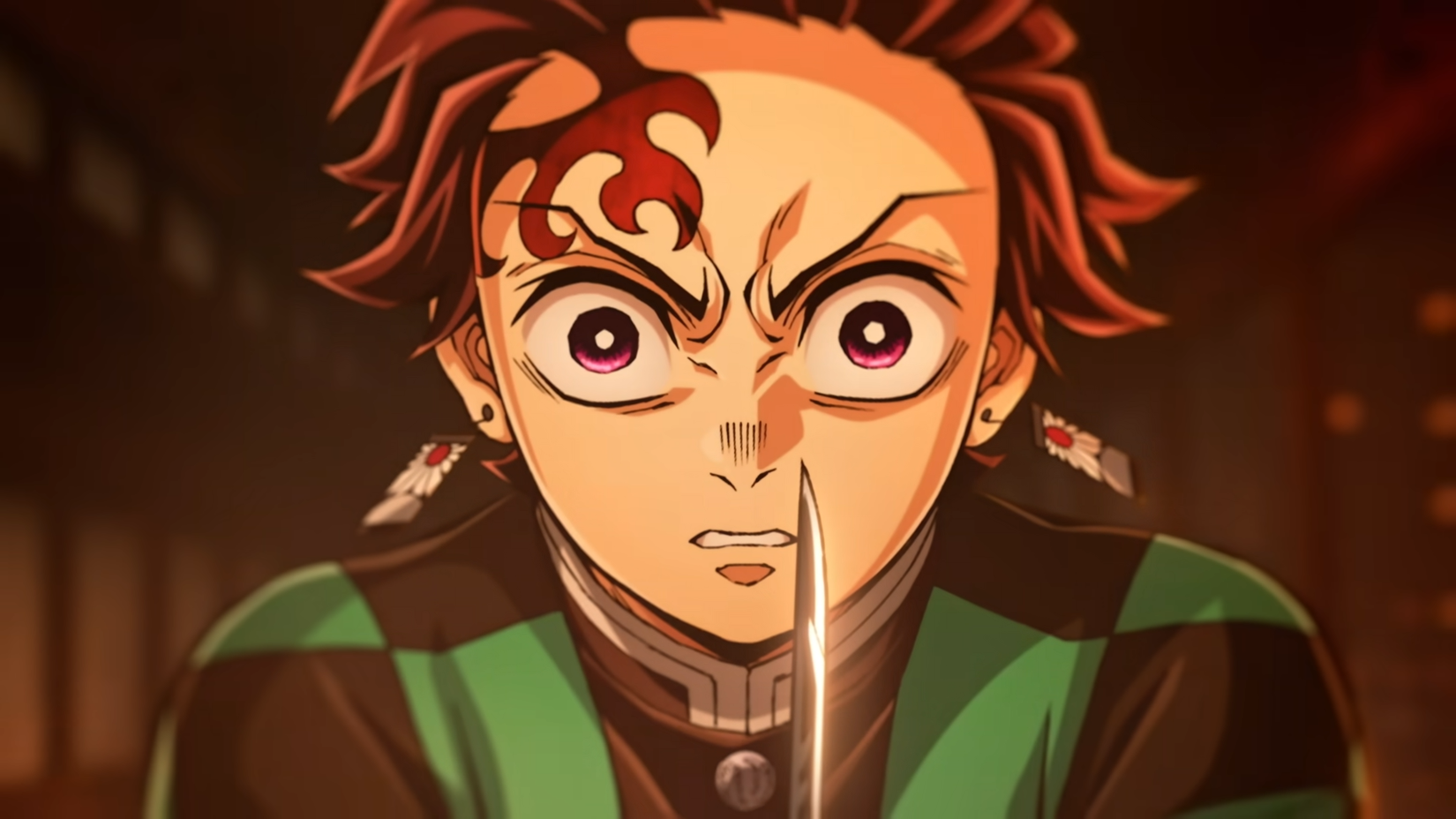 Tanjiro Kamado is staring intensely at his enemy before engaging in battle in Demon Slayer: Kimetsu no Yaiba – The Movie: Infinity Castle. 