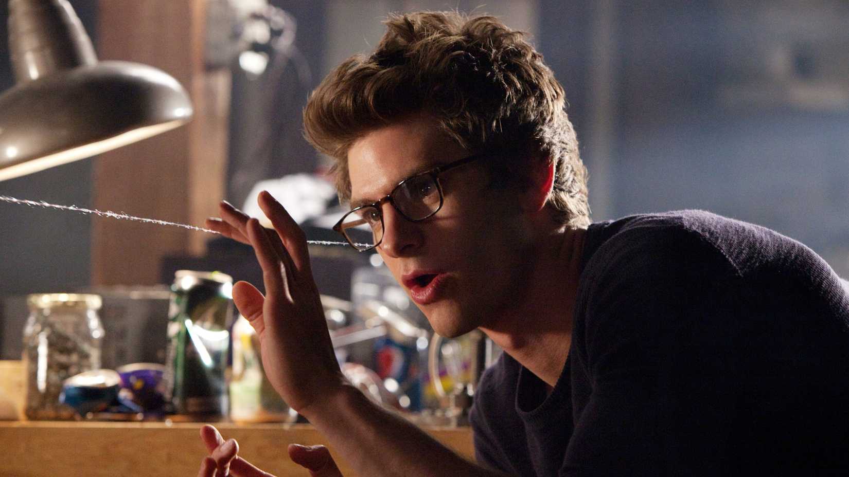 Andrew Garfield tests his web-shooters as Peter Parker in The Amazing Spider-Man