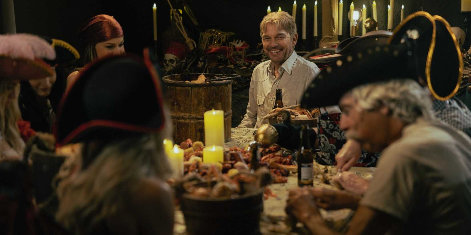Billy Bob Thornton as Tommy Norris smiling at the dinner table in Landman Season 2
