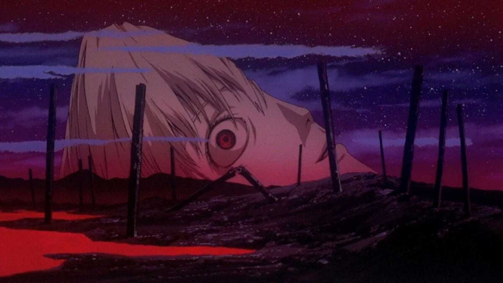 Rei's giant head crumbles in a post-apocalyptic wasteland in The End of Evangelion.