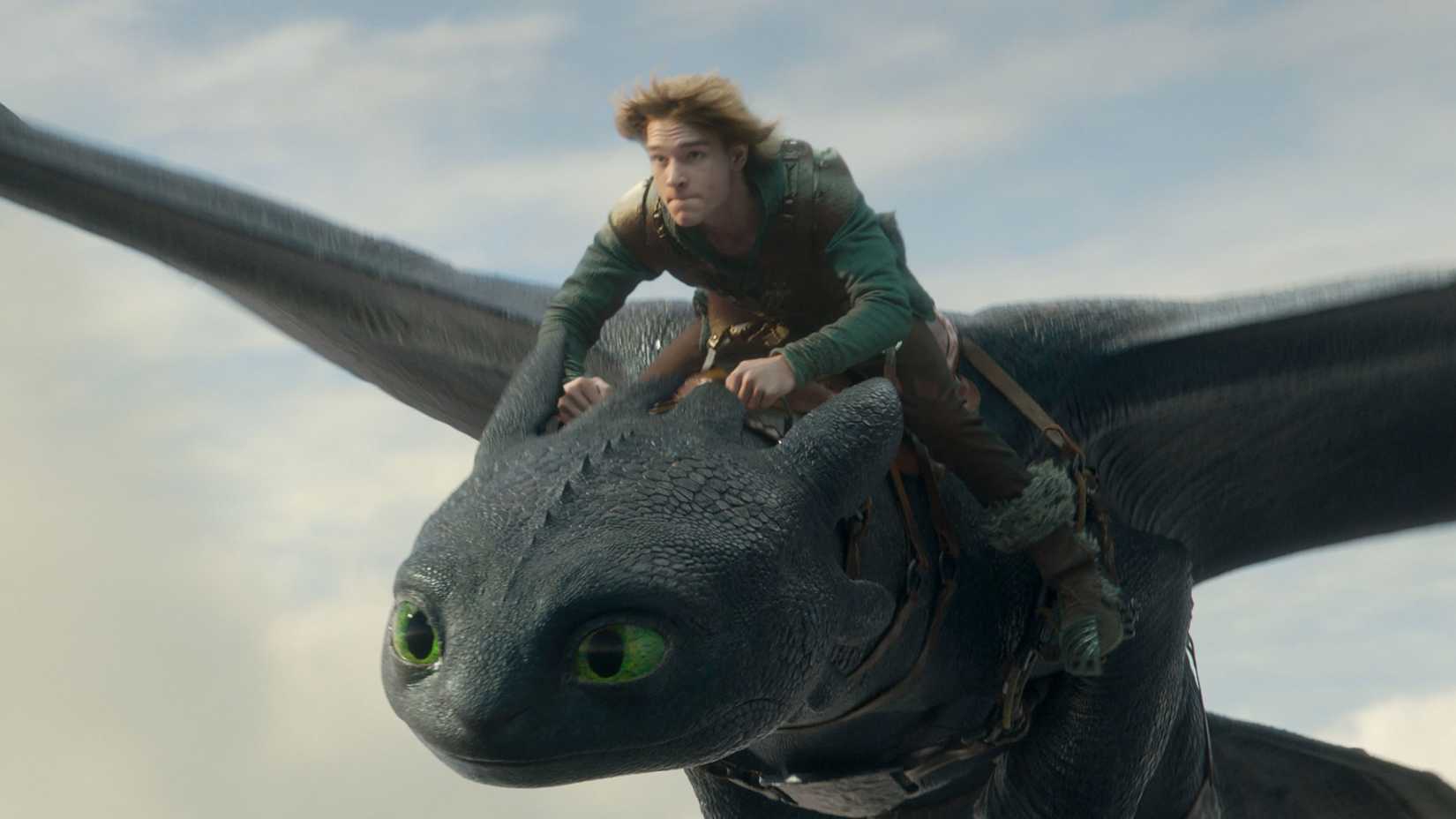 Hiccup (Mason Thames) rides Toothless through the sky in How to Train Your Dragon 2025