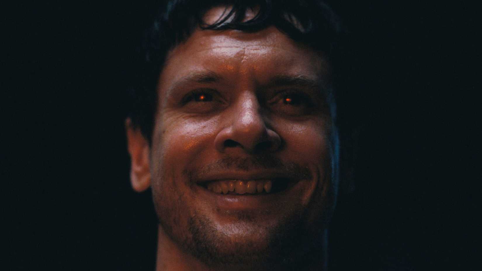 Jack O'Connell with red eyes in Sinners