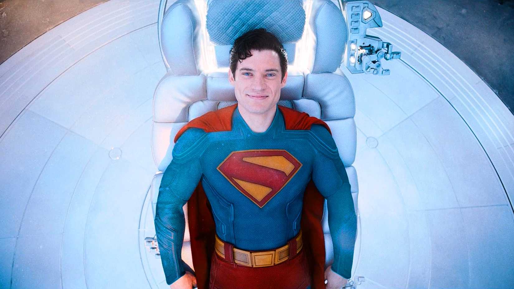 Kal-El in costume smiling lying in a chair from the 2025 Superman movie