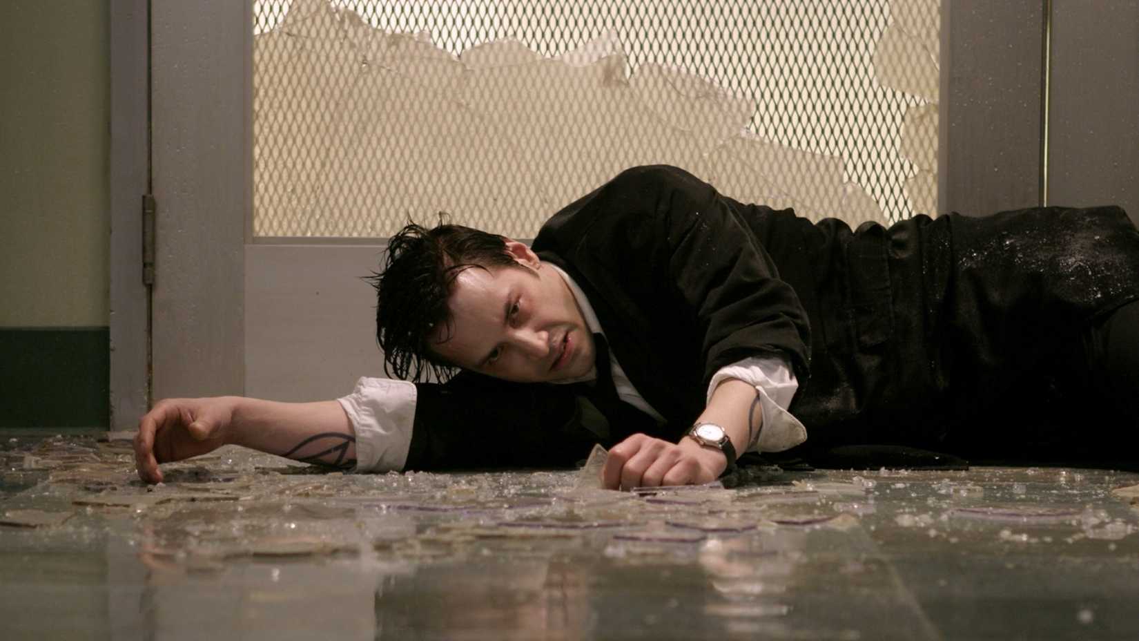 Keanu Reeves on a glass covered floor in Constantine