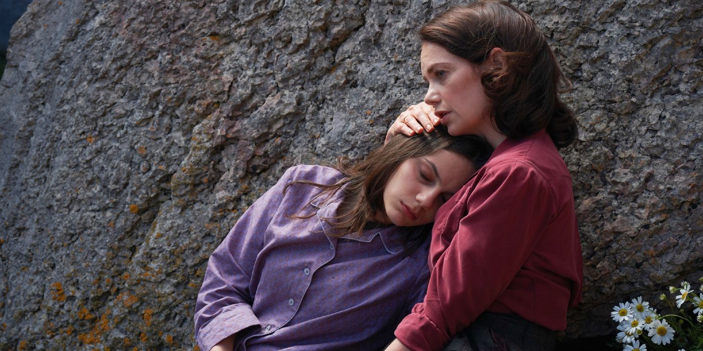 Mrs. Coulter holds Lyra, who is under a sleeping spell, in His Dark Materials