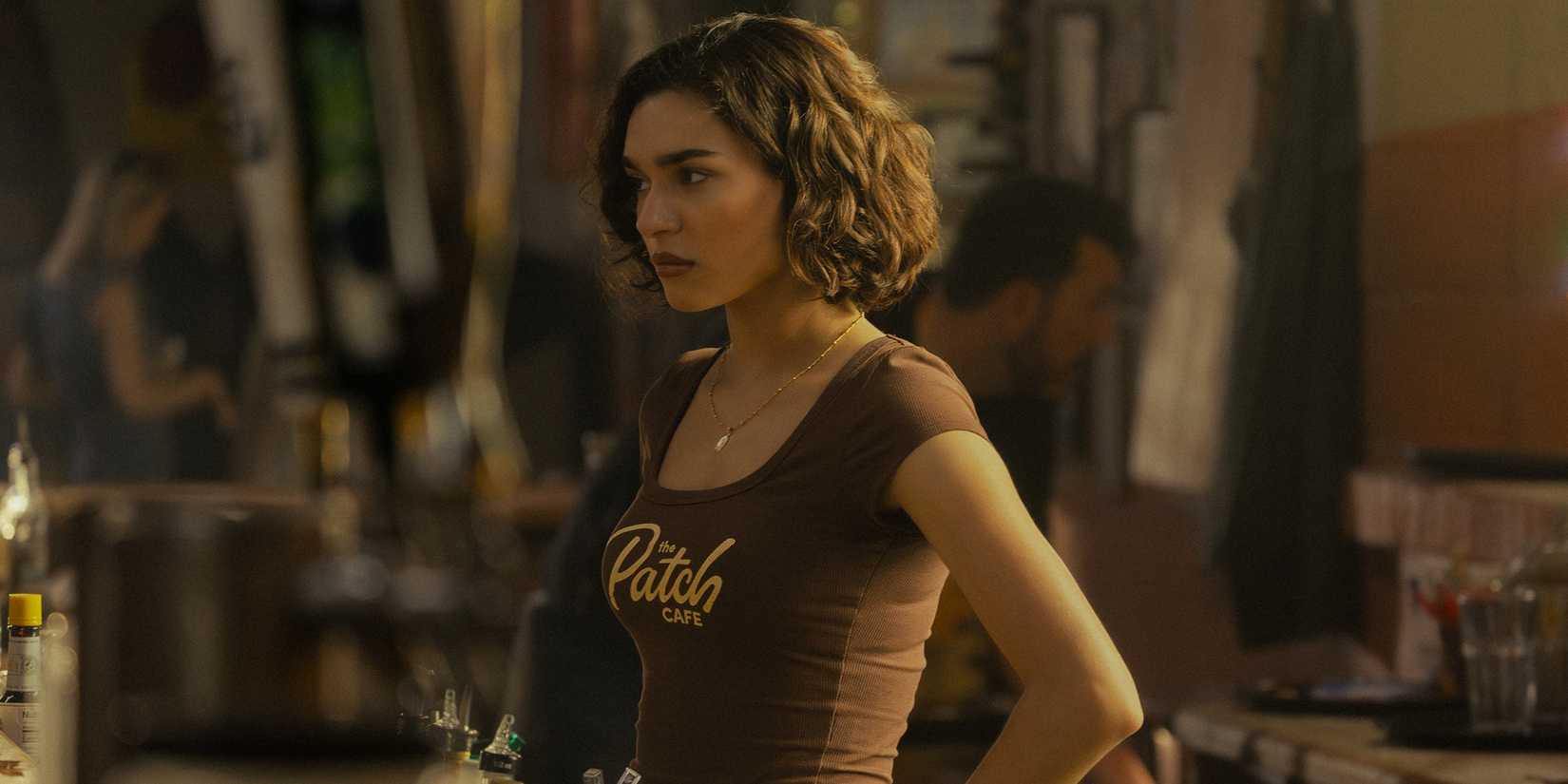 Paulina Chavez as Ariana Medina working behind the bar at the Patch Cafe in Landman Season 2 Episode 3