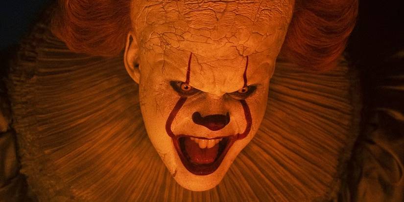 Pennywise in orange light in Welcome to Derry