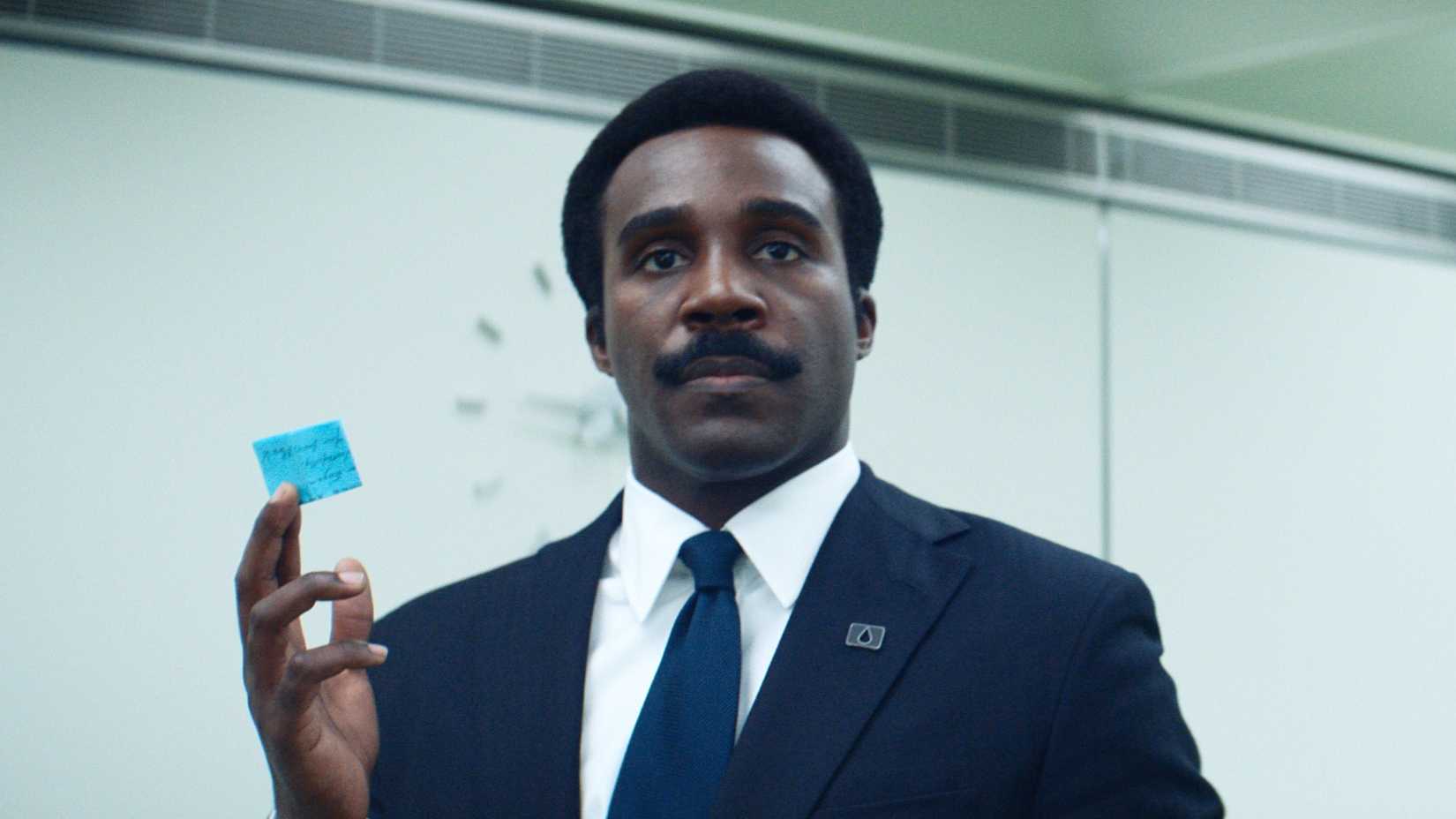 Tramell Tillman holds up a note in Severance