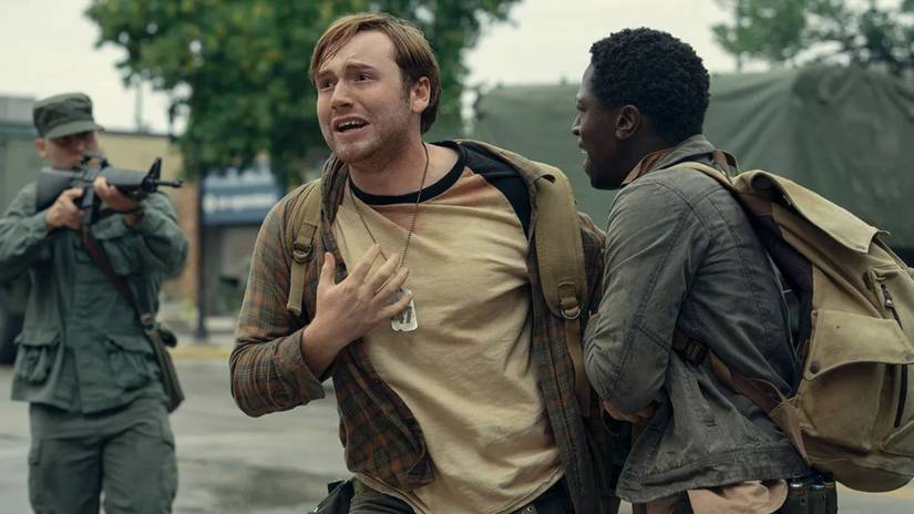 Pete holds back Ray while a soldier points his gun at them