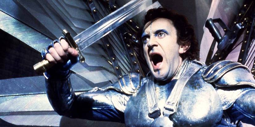 Wearing metal armor, Sam Lowry yells while holding a sword in Brazil