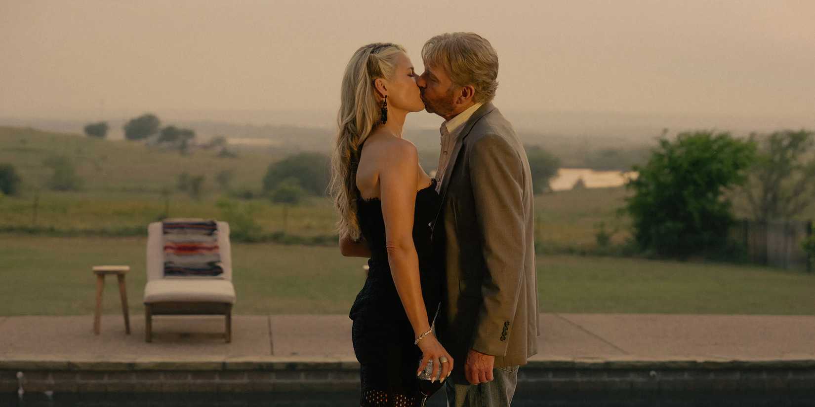 Angela Norris (Ali Larter) and Tommy Norris (Billy Bob Thornton) sharing a kiss by the pool in Landman