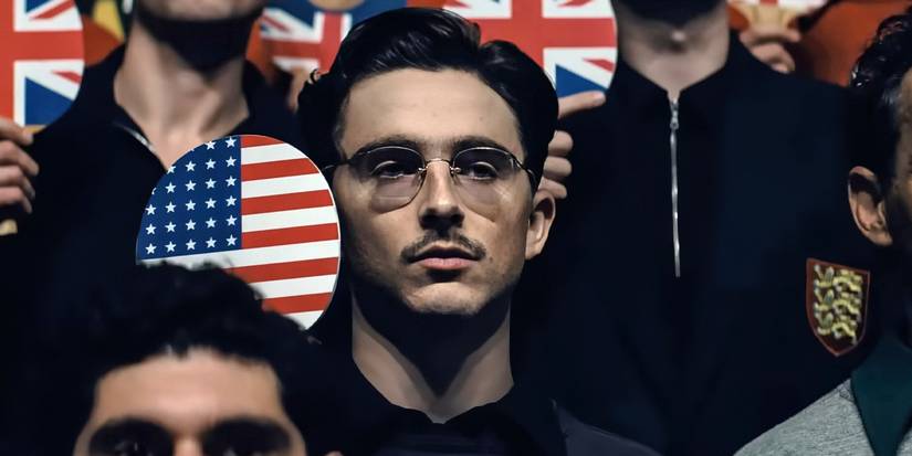 Timothee Chalamet as Marty Mauser holding up his American paddle