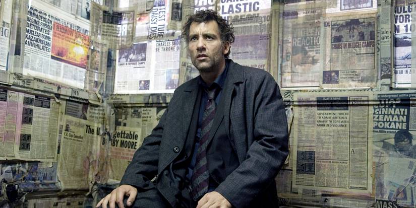 Theo Faron sits in a room covered in newspapers in Children of Men