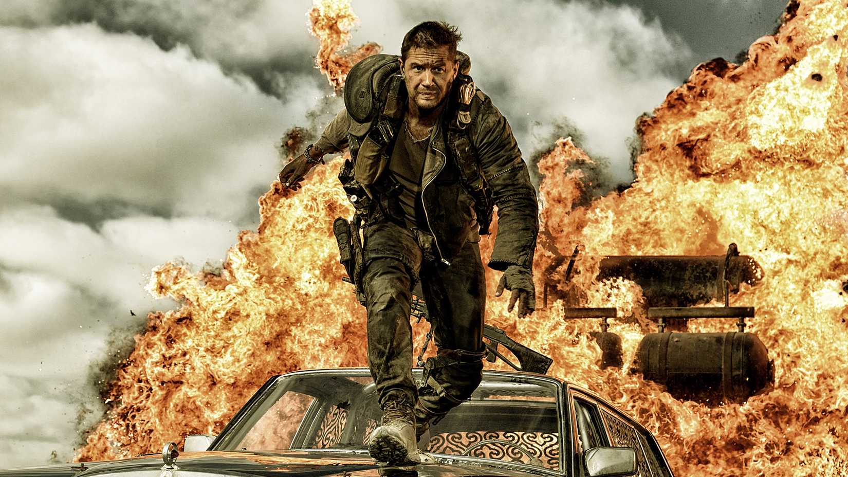Tom Hardy escapes an explosion over top of a car in Mad Max Fury Road