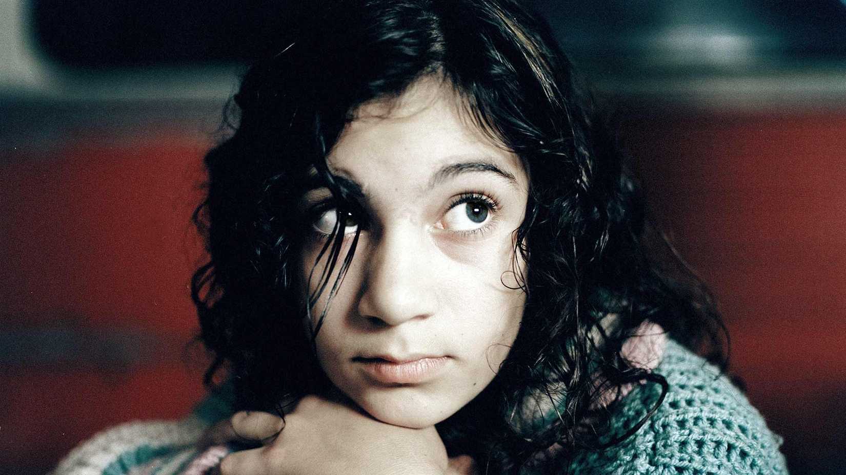 Eli the vampire sits innocently in Let the Right One In