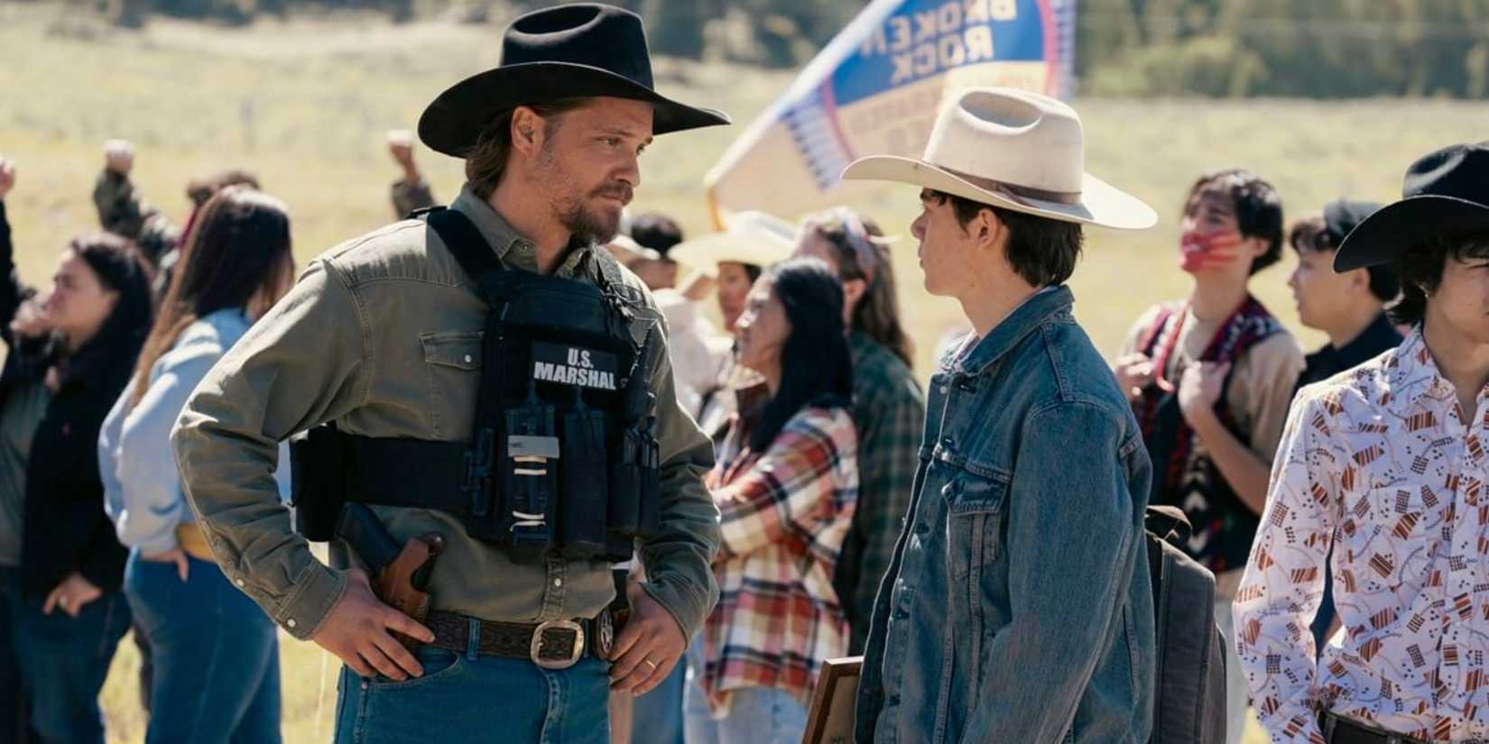 Kayce Dutton (Luke Grimes) and Tate Dutton (Brecken Merrill) at a protest on Marshals