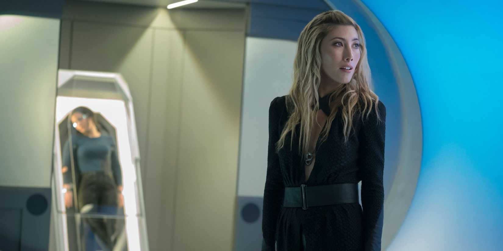 Dichen Lachman standing in front of a restrained woman on Altered Carbon.