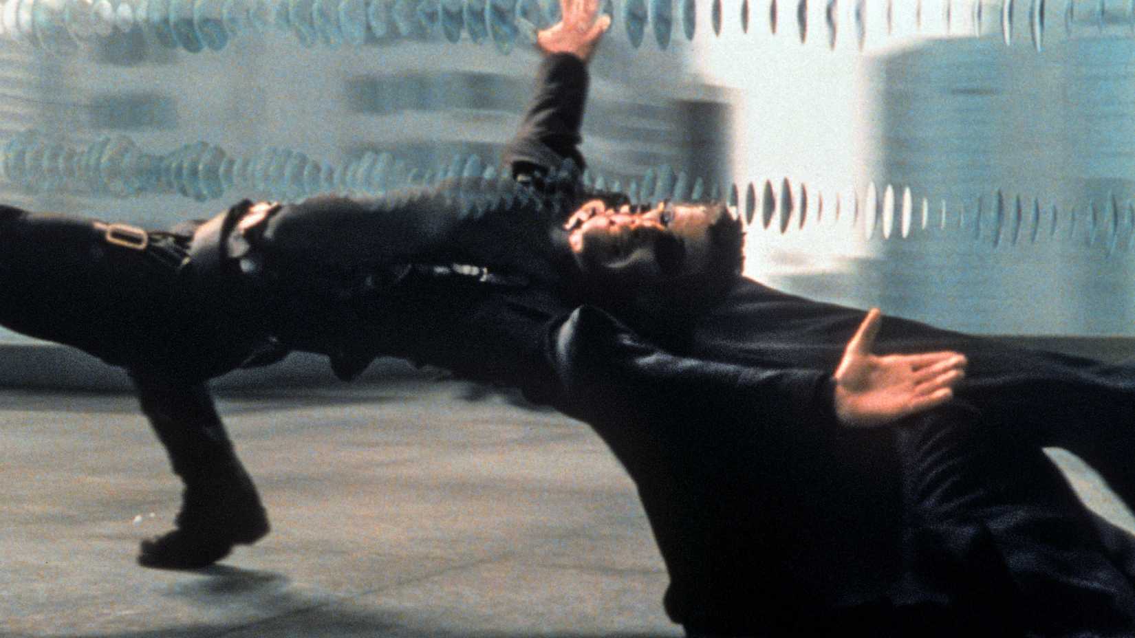 Keanu Reeves as Neo dodging bullets in The Matrix