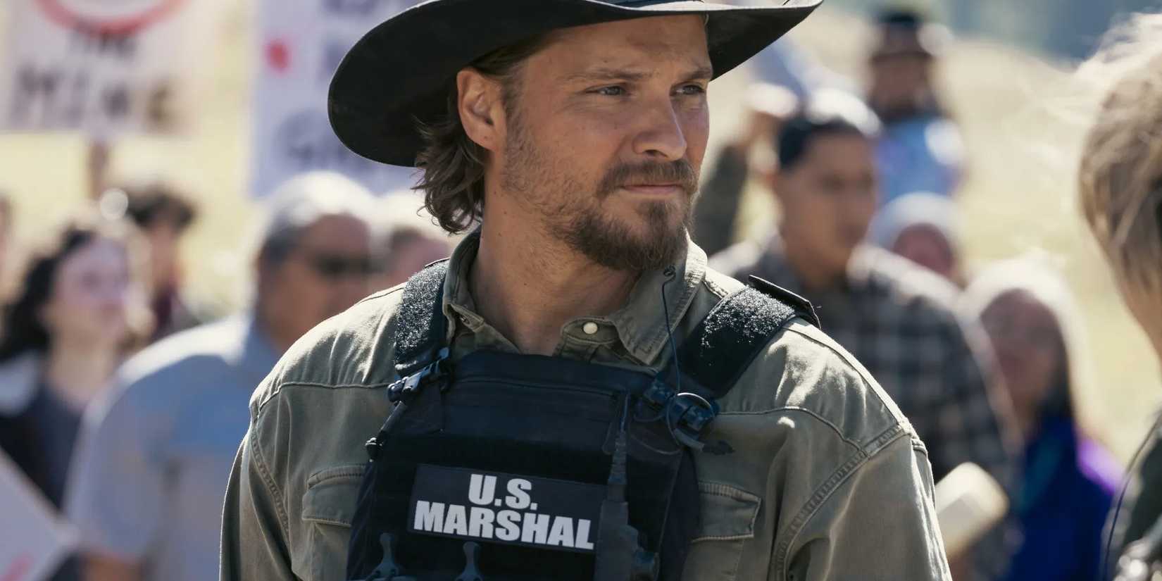 Luke Grimes as Kayce Dutton wearing a US Marshal vest in Marshals